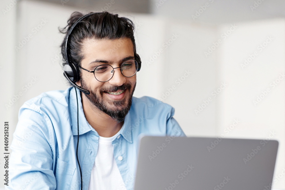 Poster hotline operator. portrait of indian customer support manager man in headset working with laptop com