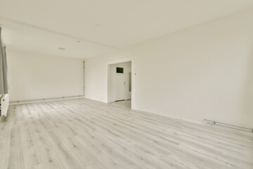 A spacious, minimalist room featuring light-colored flooring and neutral walls, creating a bright and airy feel suitable for various purposes.