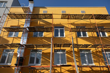 Building facade renovation, scaffolding. Extensive scaffolding providing platforms for work during renovation in a multi-story building