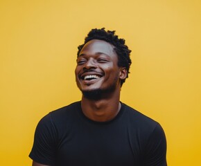 Obraz premium Joyful Laughter on Yellow: A charismatic individual radiates pure, unadulterated happiness, with a warm smile and genuine laughter. against a bold, sunny background.
