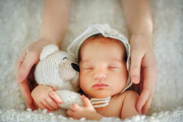 Mother's hands tenderly hold her newborn daughter. Tenderness. Mother's love. Family. The newborn...