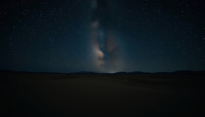 Fototapeta premium Glimmering stars twinkle over a dark desert landscape; subtle particle effects enhance the celestial scene, galaxy, nebula