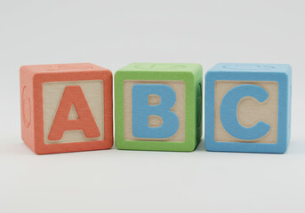 Three colorful alphabet blocks spelling out abc in a clear, educational display.