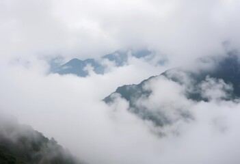 Misty mountain peaks shrouded in thick, swirling fog, image, photography