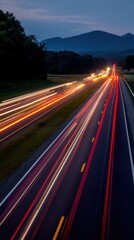Captivating long exposure of highway traffic at twilight with mountain backdrop creating a dynamic scene of motion and travel in the countryside