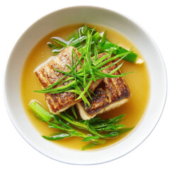 Overhead shot of miso glazed cod with greens in a white bowl. Japanese cuisine concept.