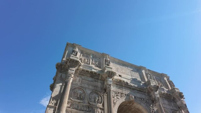 Majestic arch of constantine rising against blue sky, intricate stone carvings highlighting ancient roman architectural grandeur with birds soaring overhead