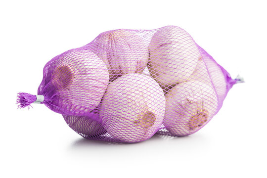Single clove garlic wrapped in a net bag isolated on white background.
