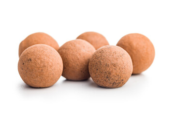 Chocolate truffles with cocoa powder and caramel filling  isolated on white background.
