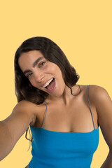 Enthusiastic young woman taking a selfie and showing excitement