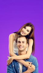 Fototapeta premium Portrait vertical image - smile cute young couple boyfriend girlfriend, beautiful woman, man in blue denim shirt cloth isolate violet purple background. Happy love concept. Banner with free text space
