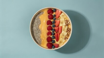 seasonal fruits Colorful bowl filled with layered fruits and grains on a pastel background.