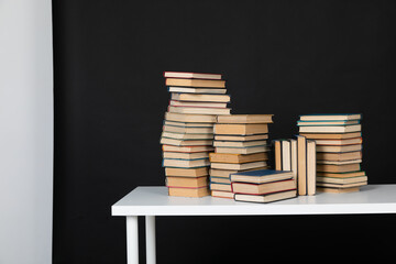 Stacks of old books for studying in the library on a black background of the university