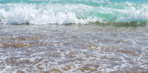 Soft wave of sea on sandy beach. Background.