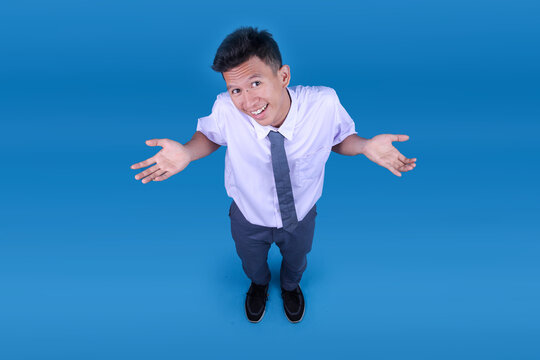 Clueless Cheerful Indonesian Student in Uniform Shrugging Shoulders Do Not Know