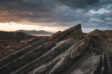 Fototapeta premium Dramatic sunset over jagged rocks mountain range landscape photography nature scenic view tranquil atmosphere