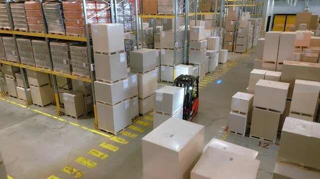 A vast warehouse reveals rows of stacked cargo boxes, emphasizing the organized chaos of a bustling logistics hub. The aerial view showcases the scale and efficiency of the storage facility.