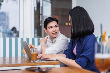 Engaging conversation between two friends in a modern cafe during late afternoon