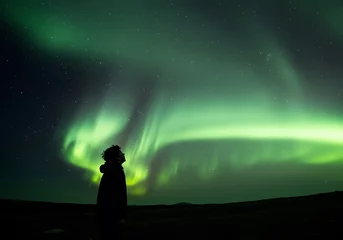 Photo sur Plexiglas Man Watching Aurora Borealis Green Sky at Night in Iceland