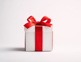 A charming gift box wrapped in crisp white paper features a vibrant red ribbon bow, creating an appealing presentation ideal for birthdays, holidays, and special events