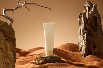 Cosmetic tube mockup placed on a wooden board desert landscape. The rocky mountain is uneven, many...