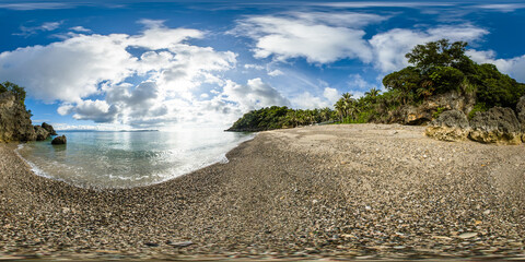 Beach with coconut trees and clear water with sun reflection. Carabao Island. Romblon, Philippines....