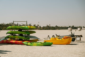 Kayaks Arranged on Sandy Beach Under Clear Sky
