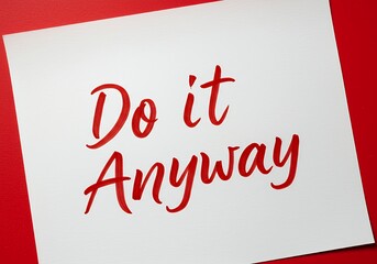 Inspirational Message Handwritten on White Paper with Red Background