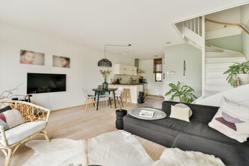 A modern, stylish living space featuring comfortable seating, light colors, and decorative indoor...