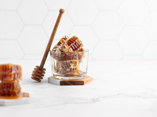 sweet honey in a glass jar and honeycombs