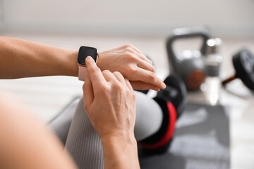 Woman with smart watch in gym, closeup view
