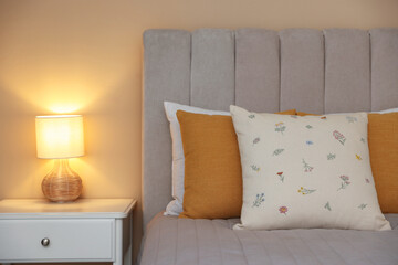 Soft decorative pillows on bed in bedroom