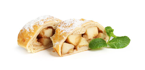 Pieces of tasty apple strudel with powdered sugar and mint isolated on white