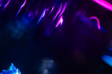 Abstract blurred colorful lens flare bokeh on black,