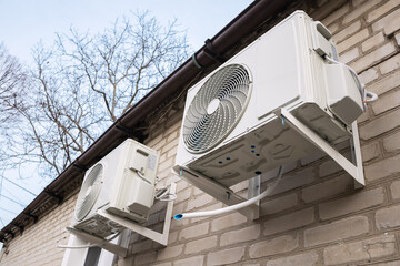 Two air source heat pumps installed on the exterior
