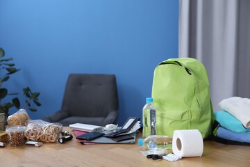 Survival kit. Different emergency supplies on wooden table indoors