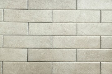 Texture of beige tiles as background, closeup