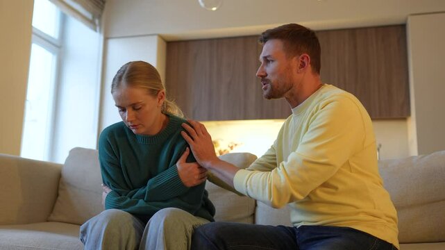 Wife uncovers betrayal. Shamed man hugging, struggles to explain to enraged hurt woman hiding ears and crying. Couple on couch serious arguing, confront, broken bond, unresolved pain, trust issues
