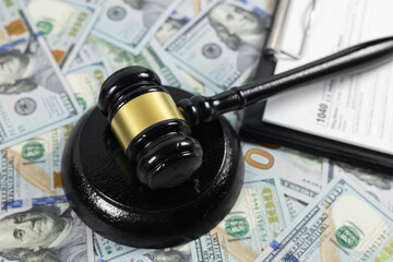 judge's gavel and 1040 IRS U.S. Individual income tax return form and refund check from United...