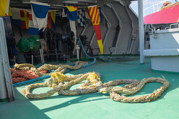 A large rope is laying on the ground in front of a building