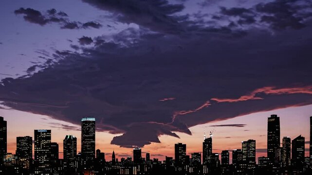 Timelapse of dark clouds forming and dissolving over urban skyline