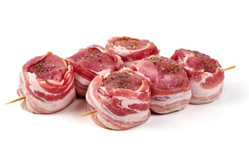 Raw Pork medallions wrapped in bacon, isolated on white background.