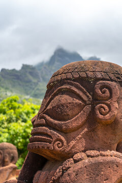 Ancient tiki statue with Mount Temetiu, Hiva Oa, French Polynesia