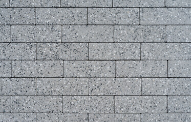 Gray cobblestone pavement of the new paving stones, top view texture,background