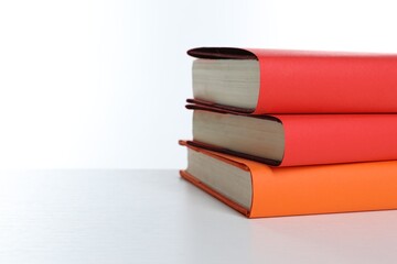 Stack of colorful books on white background