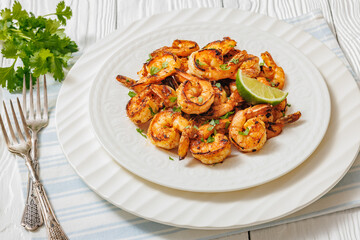 Grilled shrimp on a white plate with lime