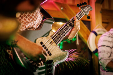 Naklejka premium A skilled musician plays bass guitar on stage, creating an electrifying atmosphere that captivates the crowd