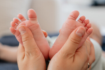 Tender Moment: Adult Hands Hold Baby Feet