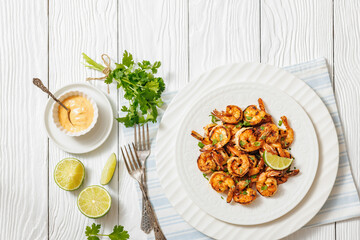 Grilled shrimp on a white plate with lime