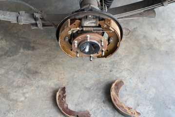 Drum brake and asbestos brake pads at car garage
